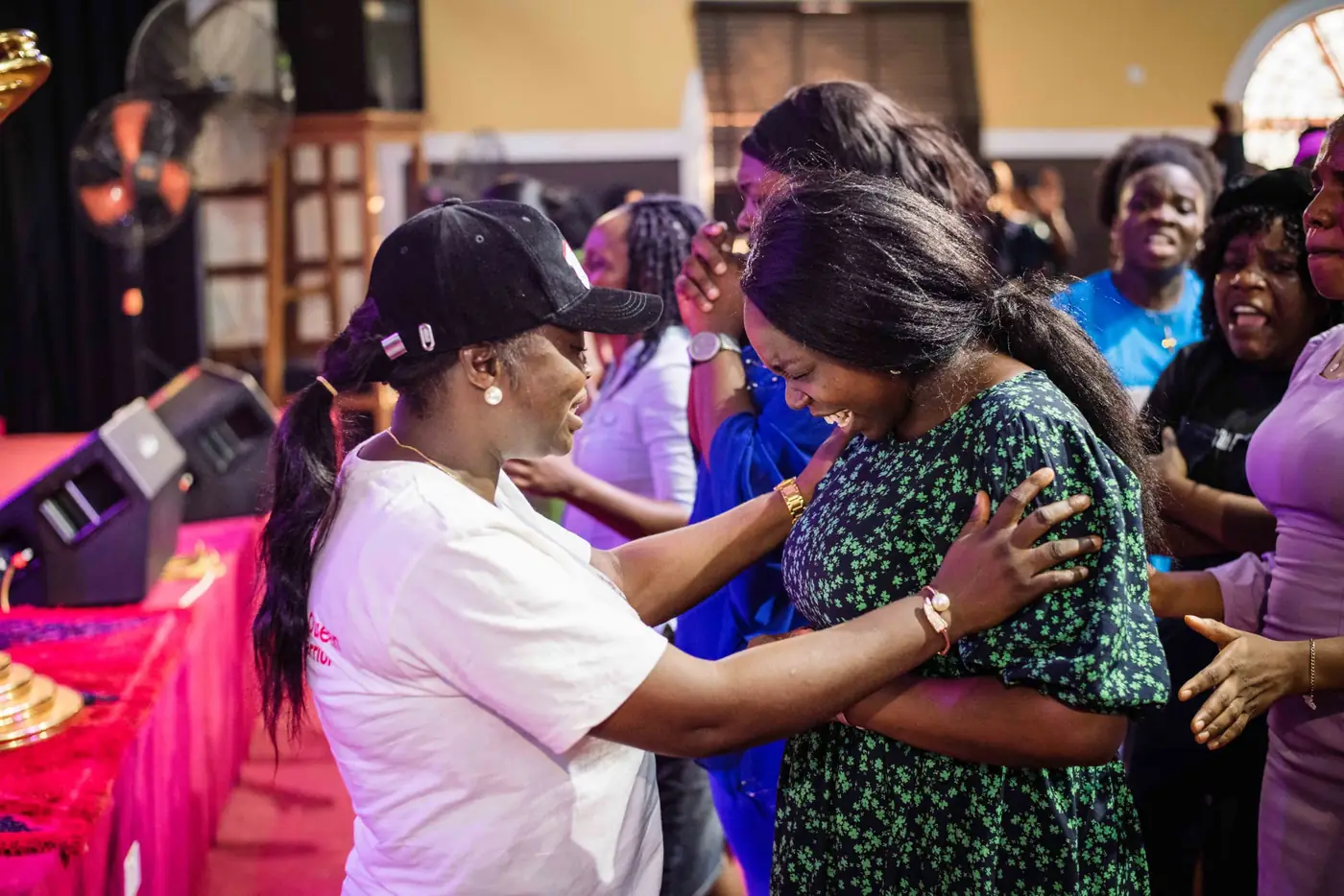 Women embracing in prayer