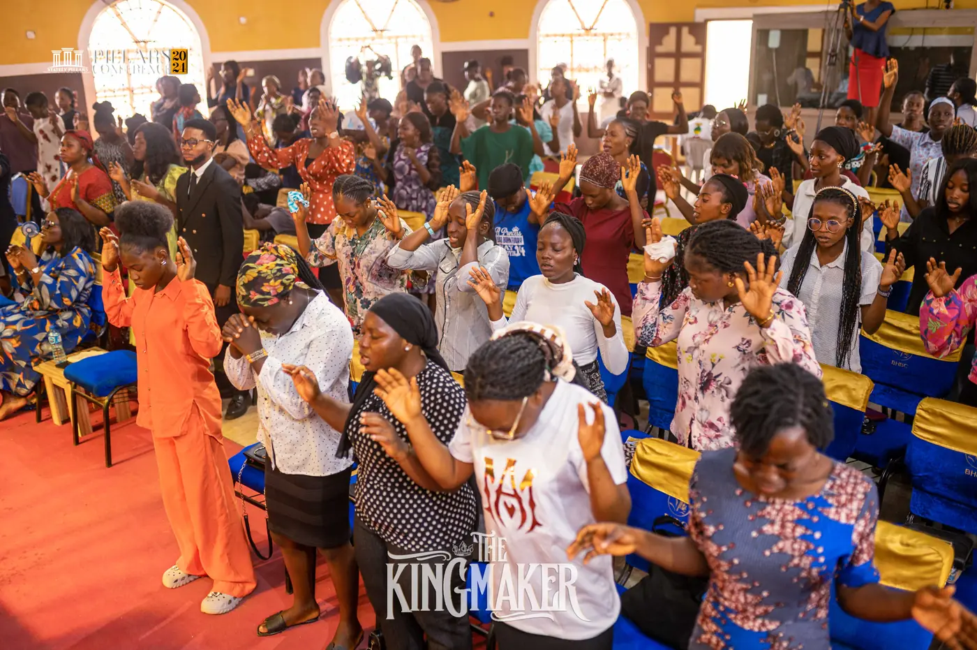 The congregation worshipping with hands raised