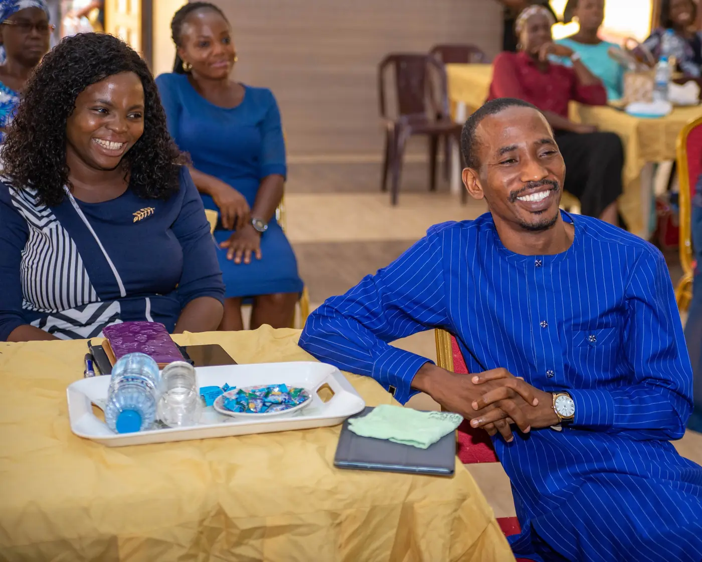 Attendees smiling at their table